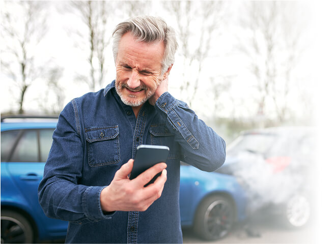 A person grimacing after a neck injury sustained in a car accident