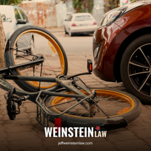 Bicycle lying on ground in front of a car following a bike vs. car accident in Tyler